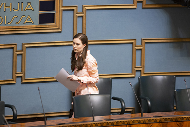 Sanna Marin taking her seat in the cleared out minister's box.
